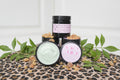 Cosmetic products on a leopard print surface with green leaves