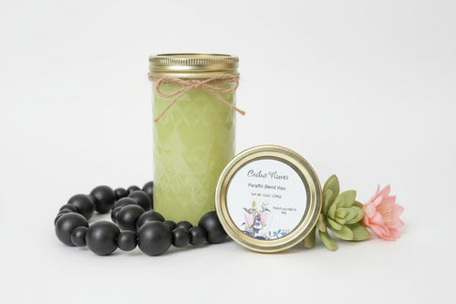 Green candle in a mason jar with decorative elements on a white background