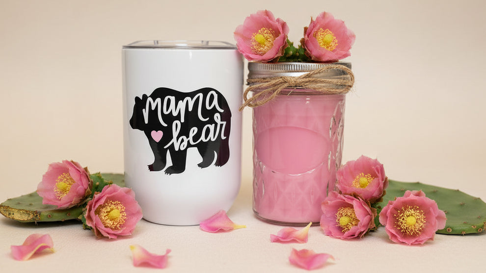 Two jars, one pink and one white with 'Mama Bear' text, with cactus and flowers