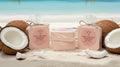 Two pink products labeled 'Mahogany Coconut' on a beach with coconuts