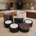 Collection of wax melts in various containers on a gray background
