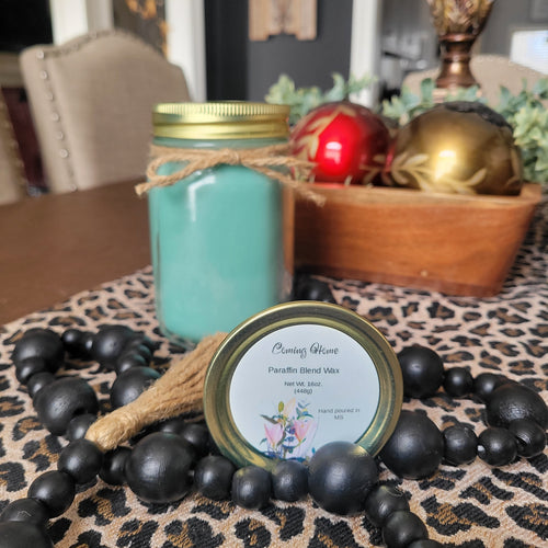 Decorative candle with black bead holder on a leopard print surface